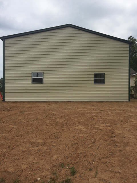 1 Back of a double wide garage building, depicting two windows.
