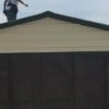 Photo of a crew member standing on top of a commercial garage.