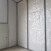 Inside view of commercial metal garage with insulation and man door.