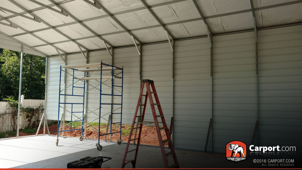 Scaffolding and ladder in front of the side of the garage.