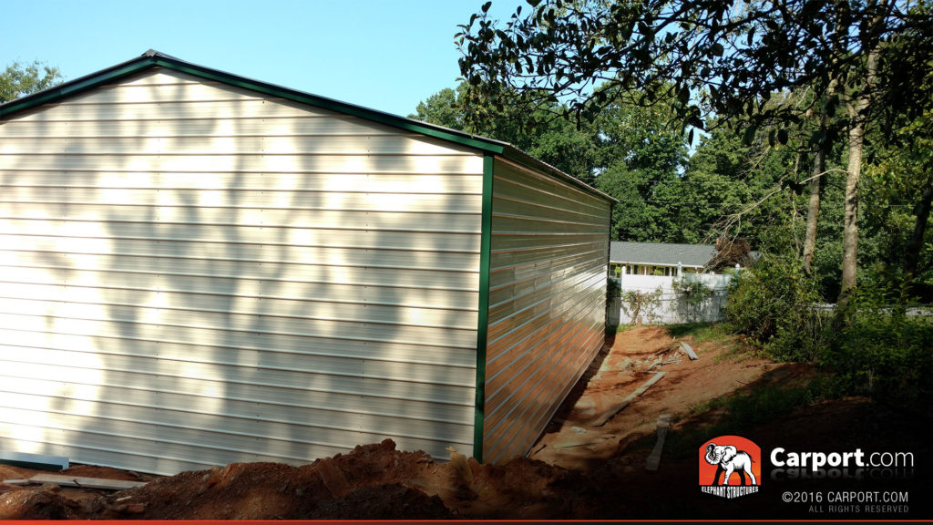 Triple wide garage viewed from the side with rear view.