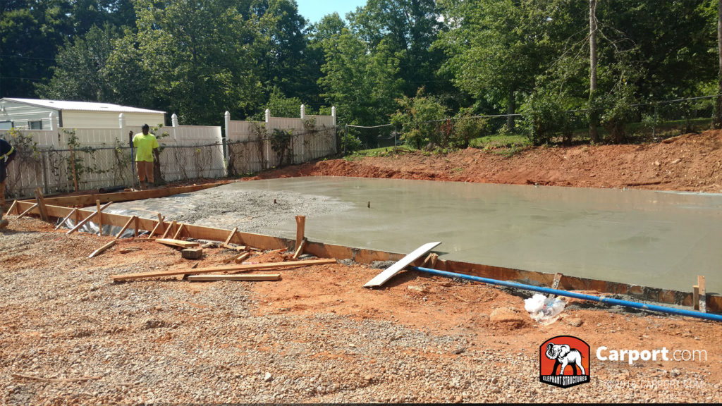 Concrete foundation still being smoothed out.
