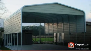 White regular-style metal carport with open sides installed on a gravel lot