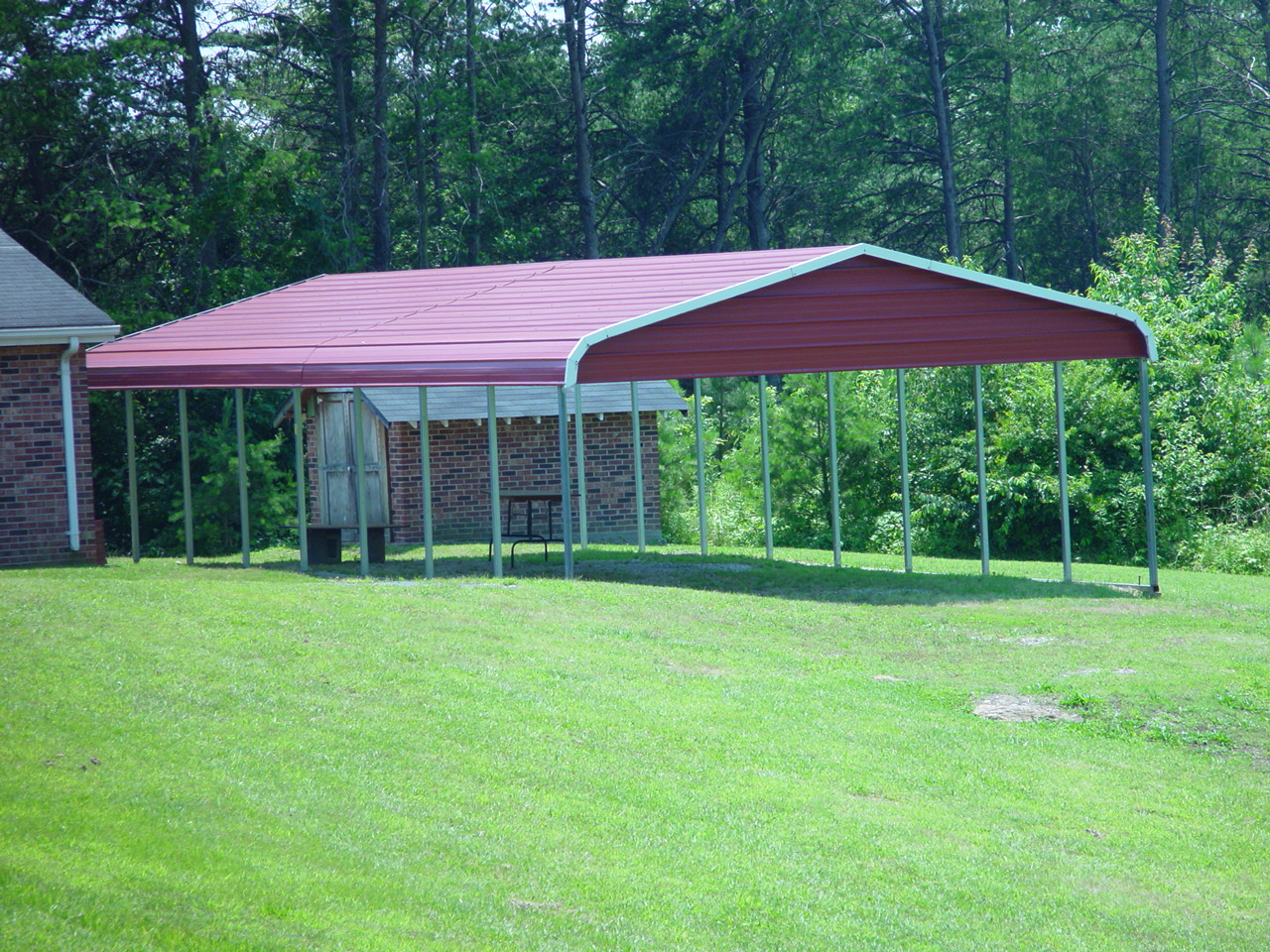 Garden yard gazebo with red gables, roof, and white trim.